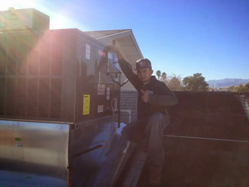 HVAC technician performing HVAC Inspection on a rooftop unit in Montpelier